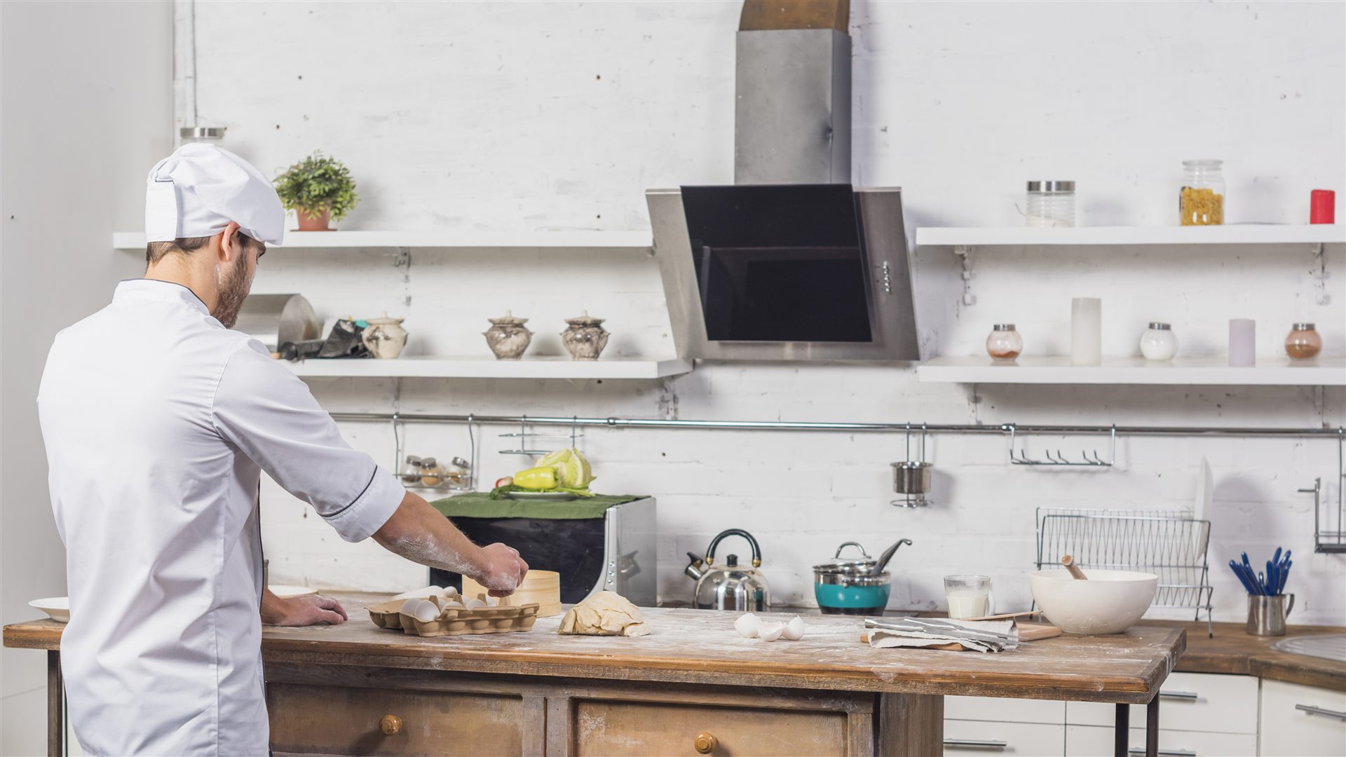 Chef preparing dough in a clean kitchen
